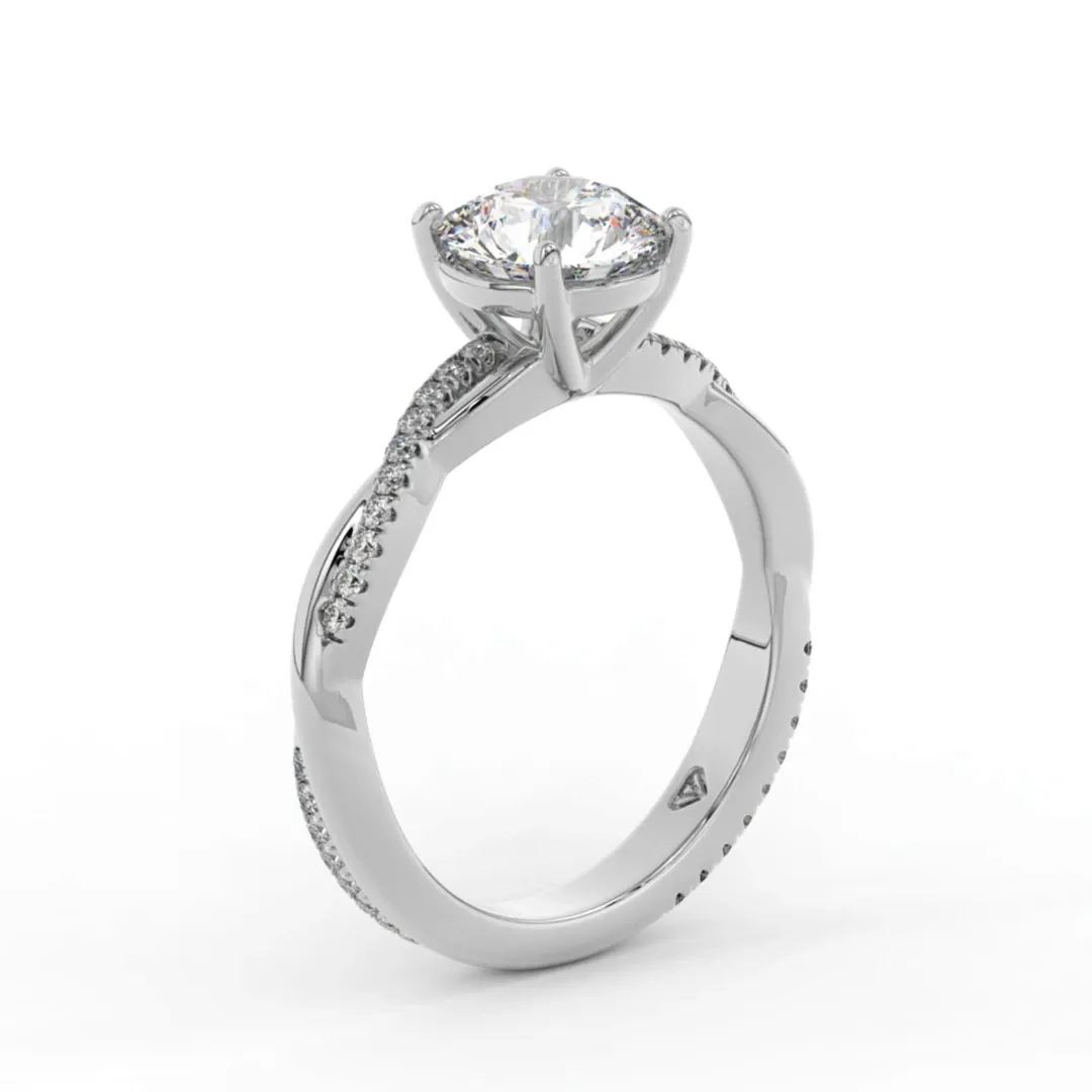 This image showcases a stunning engagement ring from Bijouterie La Voûte, featured in the Wedding Jewelry category of Mariage Elegant, Canada. The ring is crafted in white gold and features a brilliant round-cut diamond in a classic prong setting, allowing maximum light reflection. The band is elegantly adorned with smaller pavé-set diamonds, enhancing its luxurious appeal, making it a perfect choice for brides seeking elegance and sophistication for their special day.