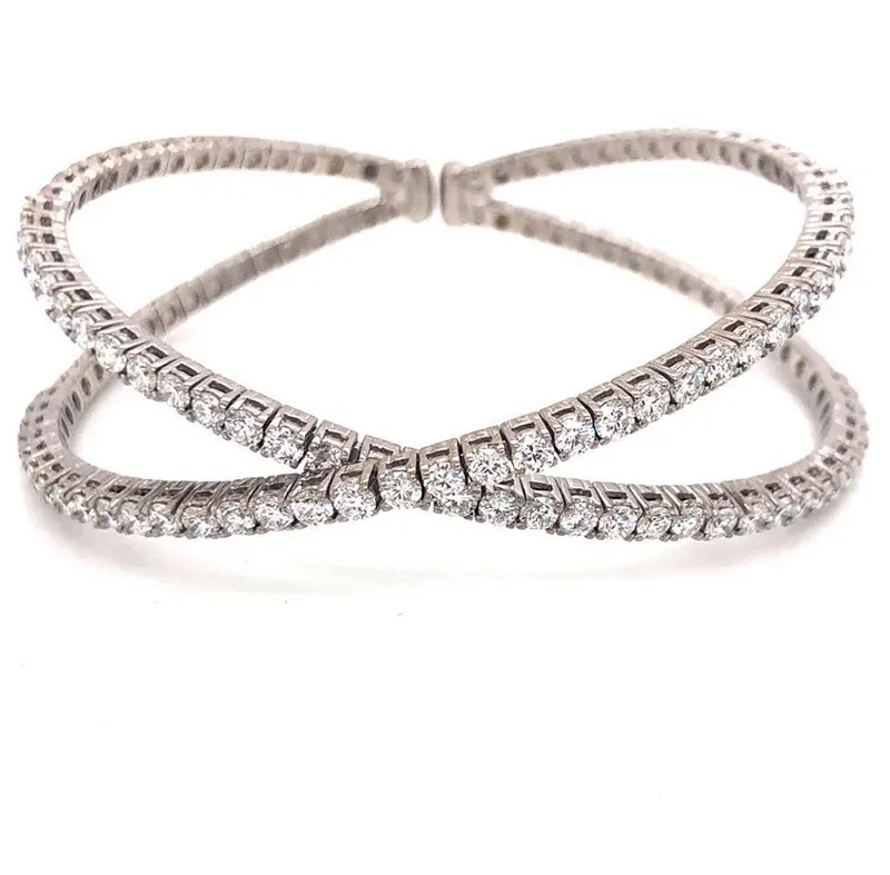 A stunning, intertwining diamond bracelet by Eternal Diamonds, featured in the Wedding Jewelry category. The bracelet showcases a delicate, crisscross design adorned with shimmering round diamonds, set in elegant white gold. This exquisite piece is perfect for adding a touch of sophistication and sparkle to any bridal ensemble, offering a timeless elegance that complements various wedding styles. Ideal for brides looking for luxurious and intricate jewelry to enhance their special day.