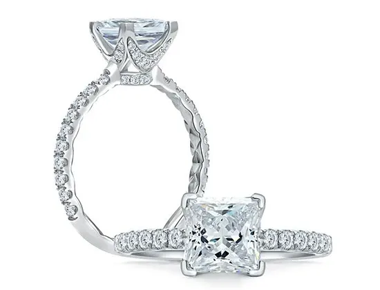 The image showcases an elegant wedding jewelry piece by Eternal Diamonds, featured on Mariage Elegant in Canada. It includes a close-up of a stunning engagement ring with a prominent princess-cut diamond at its center. The band is adorned with smaller round diamonds, creating a continuous sparkling effect. A second perspective displays the ring's intricate detailing, highlighting its craftsmanship. This piece exemplifies the luxury and sophistication of wedding jewelry, perfect for couples planning their special day.