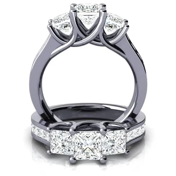 A stunning trio of diamond rings from Eternal Diamonds, featured in the wedding jewelry category. The centerpieces are beautifully cut, radiant diamonds set in polished platinum bands. Intricate detailing on the bands enhances their elegance, making them a perfect choice for a sophisticated wedding accessory. The rings' luxurious design reflects impeccable craftsmanship, ideal for those planning an elegant and memorable wedding with Mariage Elegant in Canada.