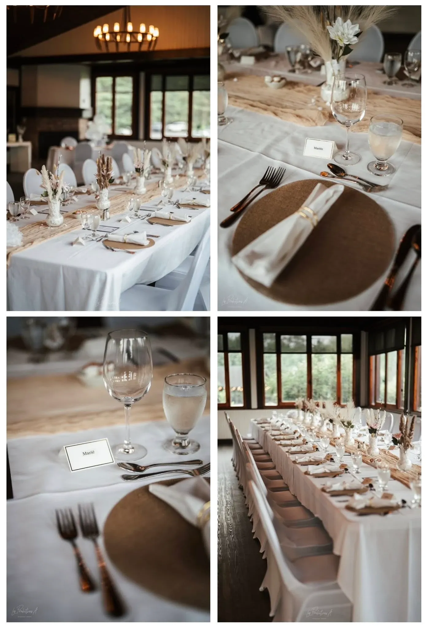The image showcases a beautifully arranged wedding reception setting captured by Les Productions A in the Wedding Photography category. It features elegantly decorated tables adorned with white linens and rustic wooden elements. Each place setting includes a round woven charger, neatly folded white napkin, and polished silverware. The tables are accented with simple yet sophisticated centerpieces of dried flowers, with name cards placed beside clear water glasses. The reception area offers warm, ambient lighting with large windows providing a view of the lush greenery outside, creating an inviting and serene atmosphere ideal for a wedding celebration.