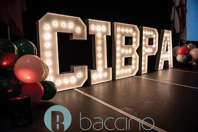 The image showcases an elegant event setup by Baccino Events, a wedding planner listed under Mariage Elegant, Canada. The focal point is a series of large, illuminated letters spelling 'CIBPA,' which stand prominently against a dimly lit background, creating a sophisticated ambiance. To the left, clusters of festive balloons in red, green, and white add a celebratory touch, suggesting a possible event theme or color scheme. The Baccino Events logo is visible at the bottom, emphasizing the vendor's branding within the wedding planning category.