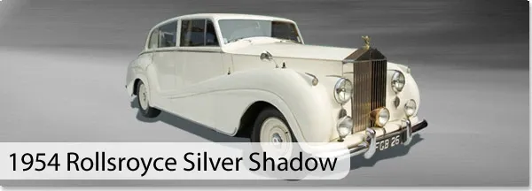 The image showcases a vintage 1954 Rolls-Royce Silver Shadow in pristine white, highlighting its elegant and classic design. This luxury vehicle, available through vendor CM Limo, is perfect for weddings, offering a touch of sophistication and timelessness. The sleek lines and polished chrome accents are emphasized against a neutral background, making it an ideal choice for couples seeking a refined and memorable entrance on their special day. The category for this service is Wedding Limousine, providing an exemplary transportation option for bridal parties in Canada.