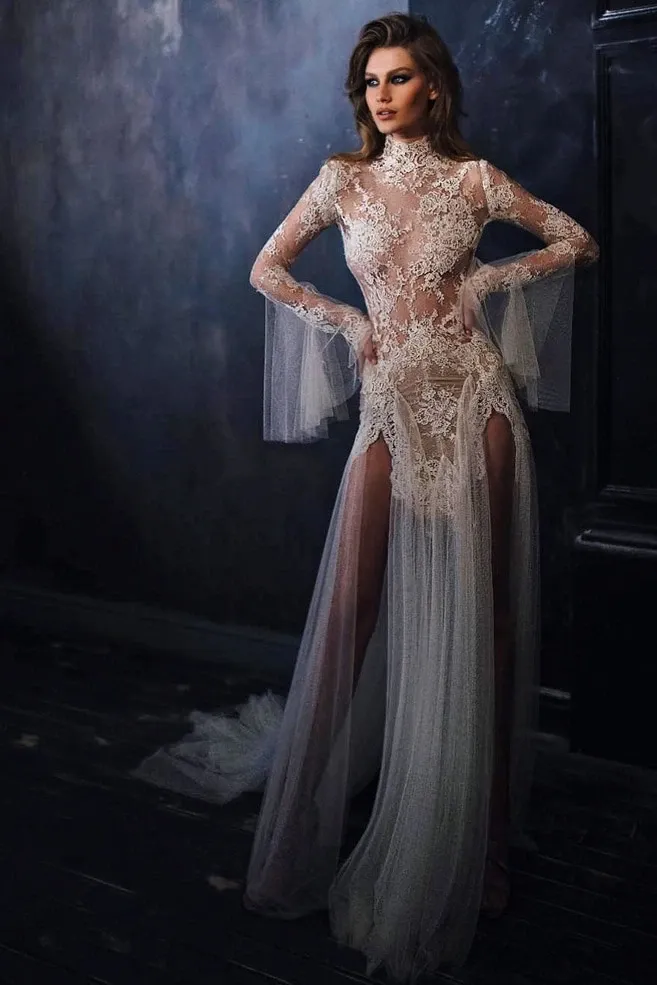 This image features a stunning bridal gown by White Montreal in the Wedding Dress category. The dress showcases an intricate lace design with a high neckline and long sleeves. The sheer fabric artfully blends elegance and modern style, with a flowing tulle skirt that adds a dramatic flair. Perfect for elegant weddings, this gown embodies sophistication and style, suitable for brides seeking a distinctive look.