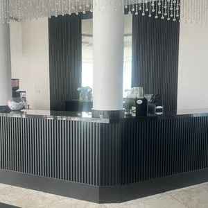 The image showcases the elegant interior of Plaza Vogue, a top-tier wedding venue listed under Mariage Elegant, Canada. It features a sophisticated reception area with a stylish black, ribbed counter complemented by sleek white columns. Gleaming crystal bead curtains hang from the ceiling, adding a touch of luxury and glamour. The scene embodies a modern and chic ambiance, perfect for hosting upscale wedding events.