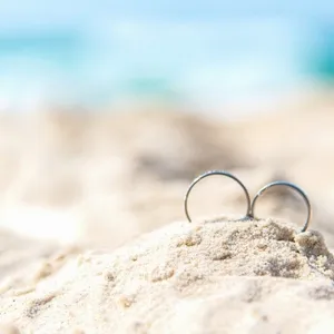 Wedding rings for couple lover on the sandy beach. Engagement rings in honeymoon vacation in tropics. Valentine Concept. soft and select focus Wedding rings for couple lover on the sandy beach. Engagement rings in honeymoon vacation in tropics. Valentine Concept. soft and select focus